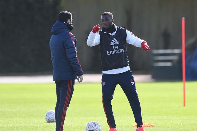 Mikel Arteta with Arsenal's record signing Nicolas Pepe in training
