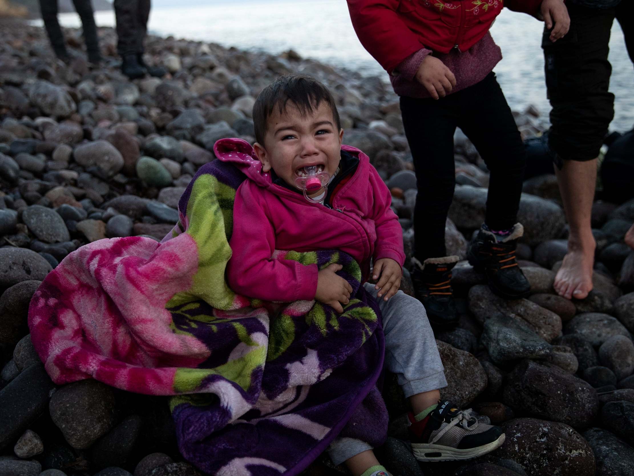 Child drowns off Greece as coastguard seen apparently trying to capsize boat full of refugees before attacking them with stick
