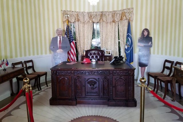 Customers are invited to take a picture with the president's likeness behind a replica-Oval Office desk