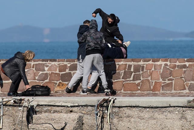 Locals who prevent migrants on a dinghy from disembarking at the port of Thermi beat a journalist on the island of Lesbos, Greece, on 1 March
