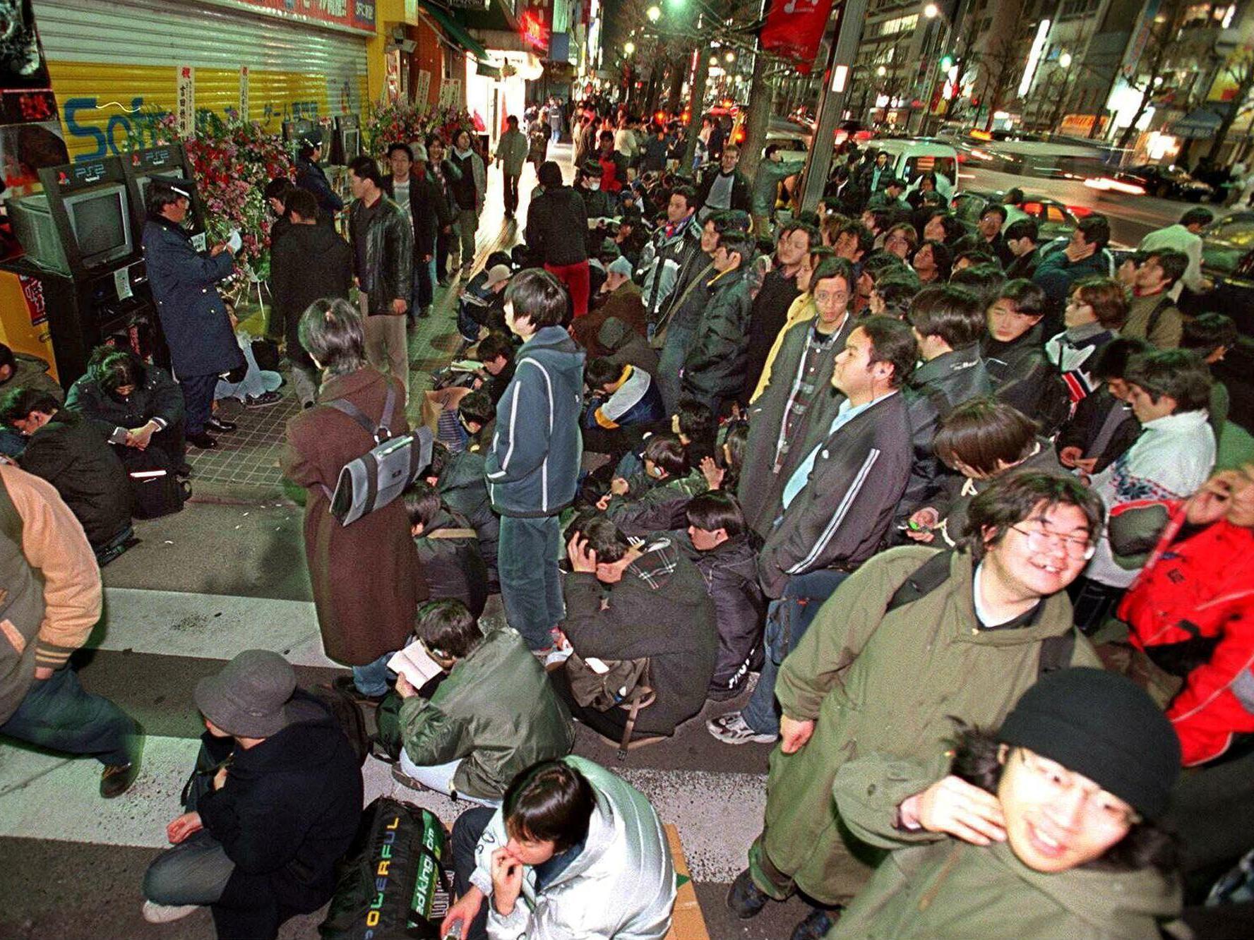 Gamers crowd outside a Japanese computer shop on 3 March 2000, waiting for the PS2 to go on sale (AFP/Getty)