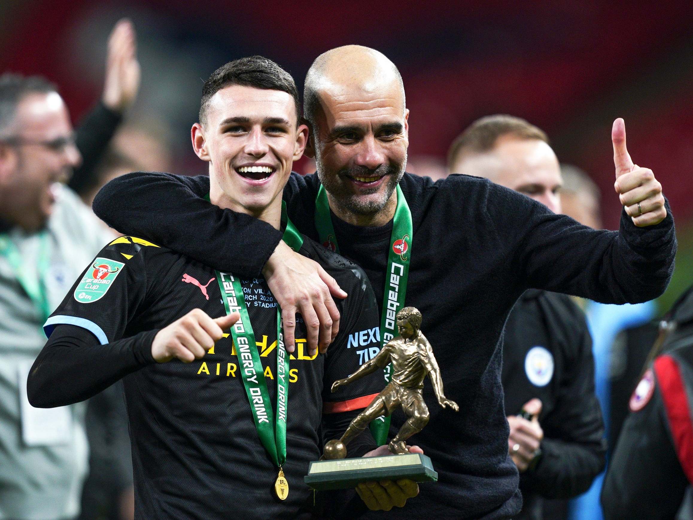 Phil Foden and Pep Guardiola celebrate after the Carabao Cup final