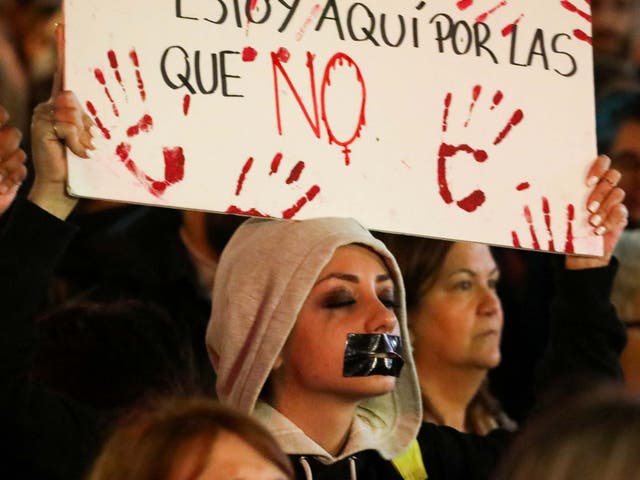 A protester demonstrates outside the Justice Ministry in Madrid in November 2019 over a gang-rape case ruling