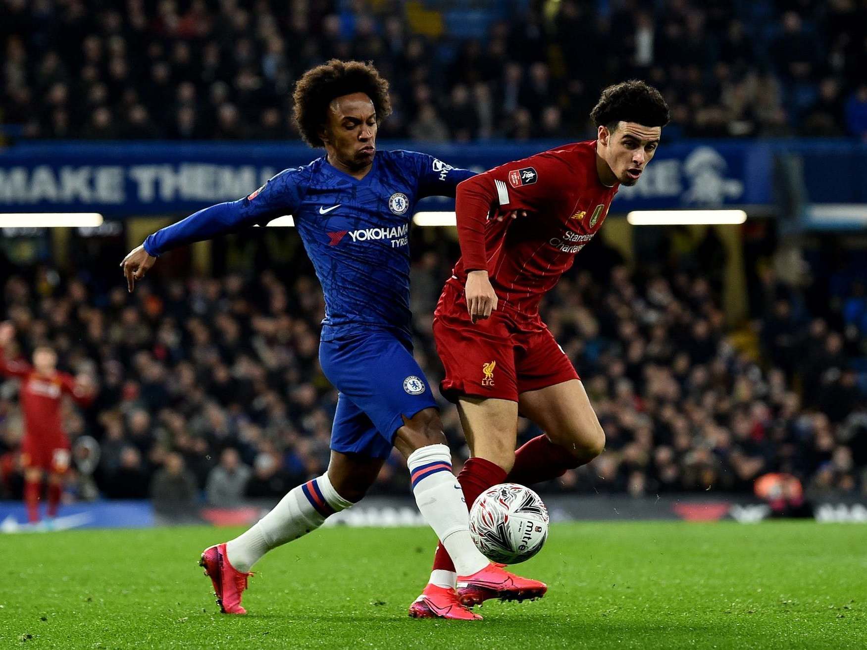 Willian (left) battles for the ball with Liverpool's Curtis Jones
