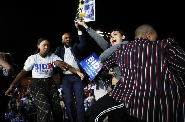 Joe Biden's adviser Symone Sanders tackles an anti-dairy activist at his Super Tuesday victory rally.