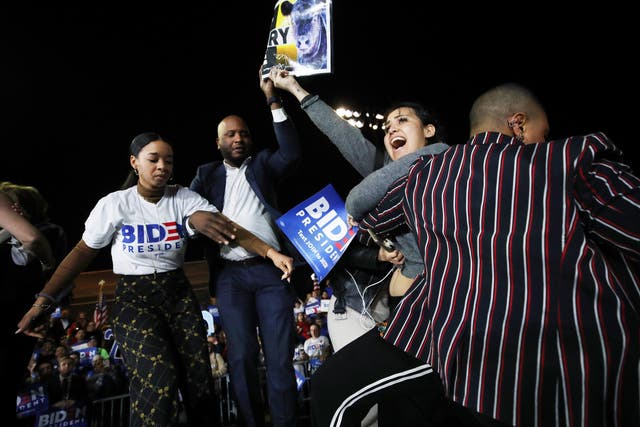 Joe Biden's adviser Symone Sanders tackles an anti-dairy activist at his Super Tuesday victory rally.