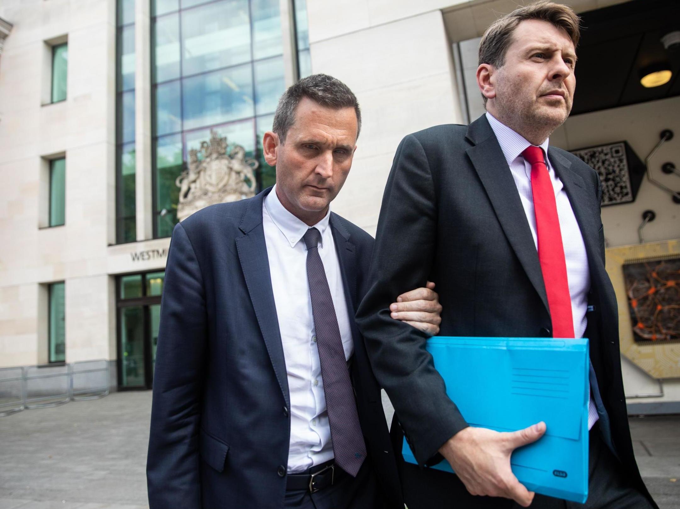 Baron Holmes of Richmond (left) leaves Westminster Magistrates' Court where he appeared on charges of sexual assault on 22 July 2019.