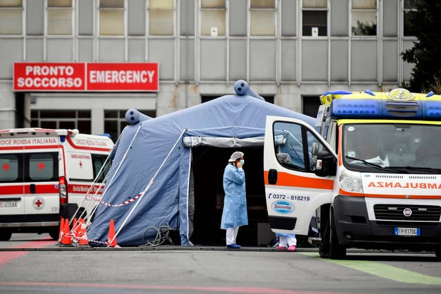 Paramedics stand by a tent that was set up outside the emergency ward of Cremona's hospital