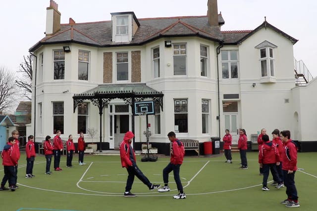 Pupils greet each other with a foot-to-foot tap instead of a handshake at St Christopher’s Prep School, Hove, as part of efforts to prevent the spread of coronavirus