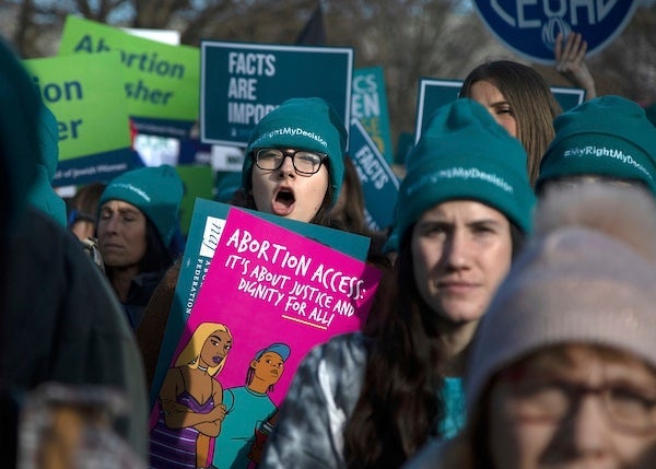 Abortion rights activists take part in a rally outside the Supreme Court as justices consider the first major abortion case since Donald Trump came to power