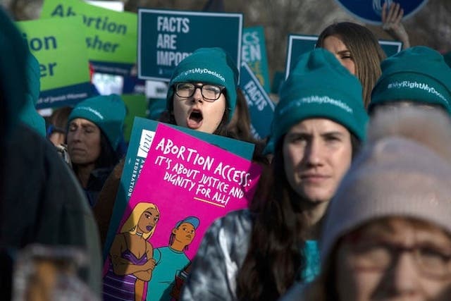 Abortion rights activists take part in a rally outside the Supreme Court as justices consider the first major abortion case since Donald Trump came to power