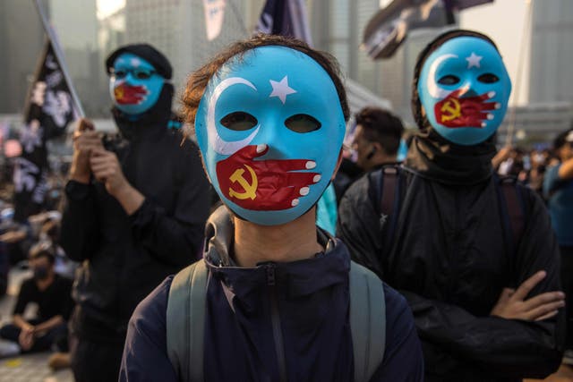 Protesters attend a rally in Hong Kong to show support for the Uighur minority in China