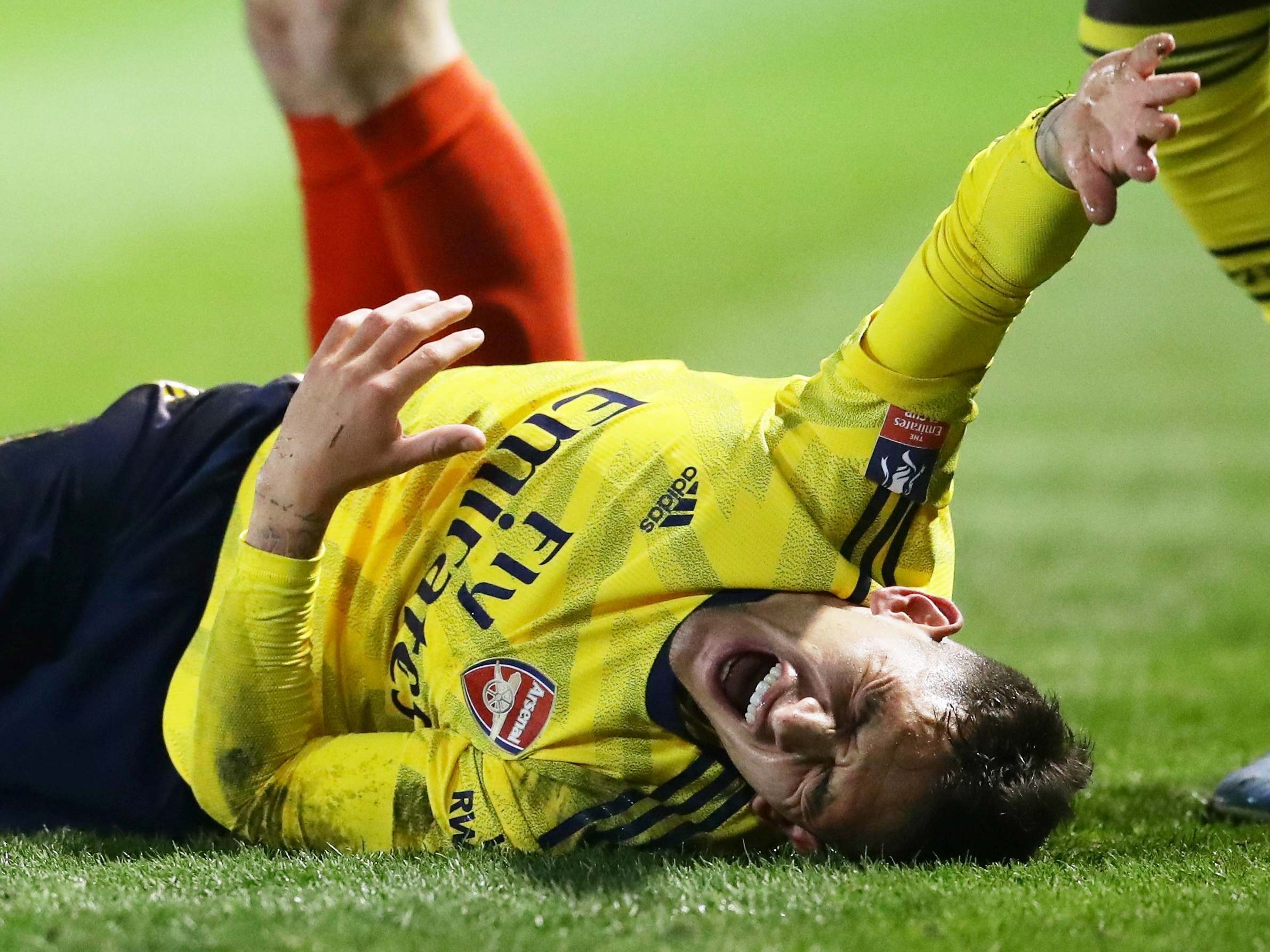 Lucas Torreira reacts after suffering his injury against Portsmouth (REUTERS)