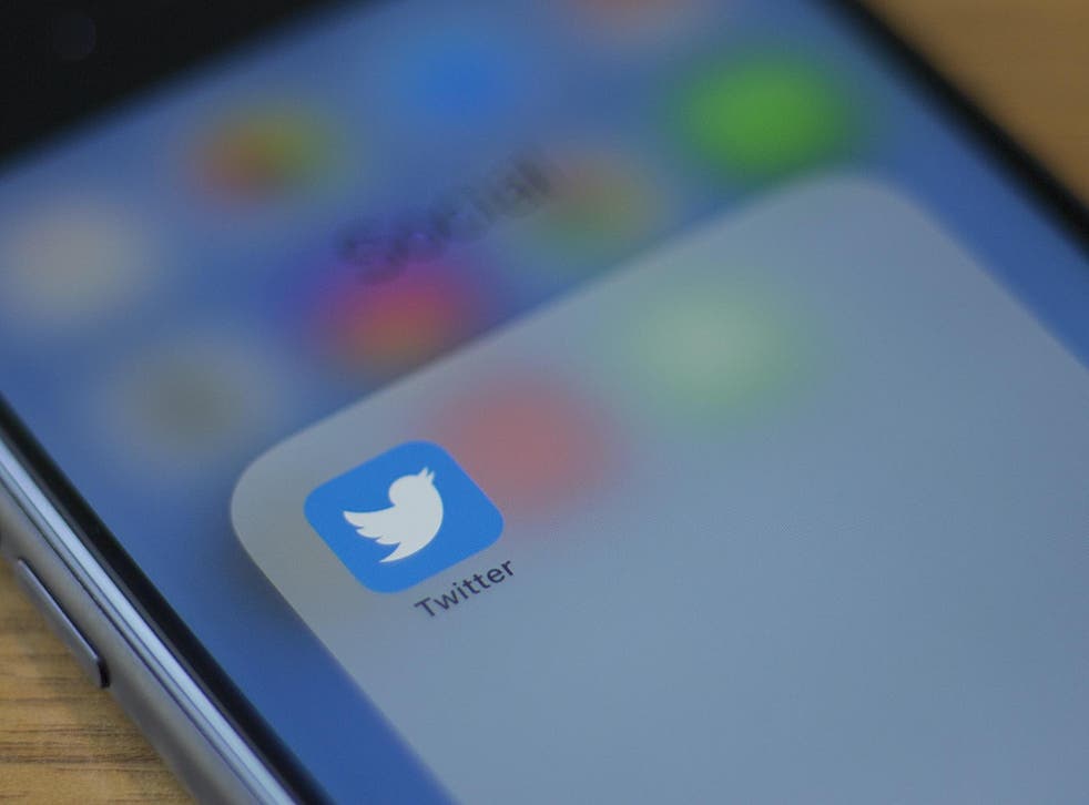 The Twitter logo is seen on a phone in this photo illustration in Washington, DC, on July 10, 2019