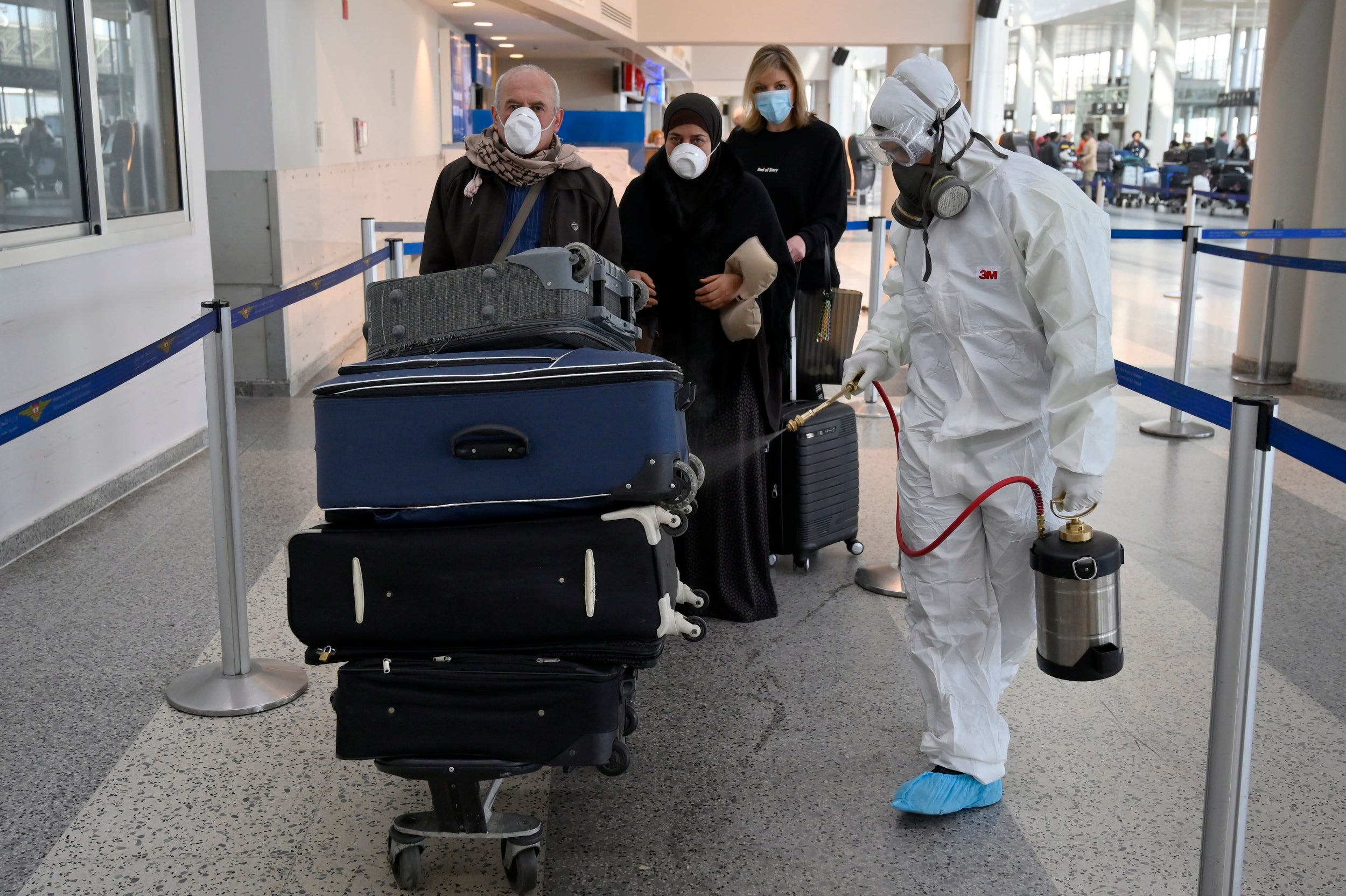 A worker sprays disinfectant as a precaution against the spread of coronavirus at Rafik Hariri international airport in Beirut