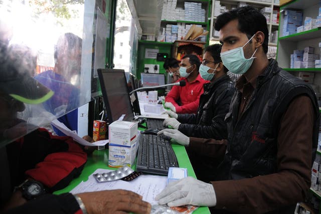 People wear protective masks as a precaution against coronavirus in Delhi on Thursday