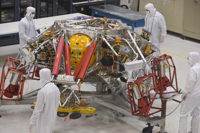 NASA engineers and technicians examine the descent stage of the Mars 2020 spacecraft