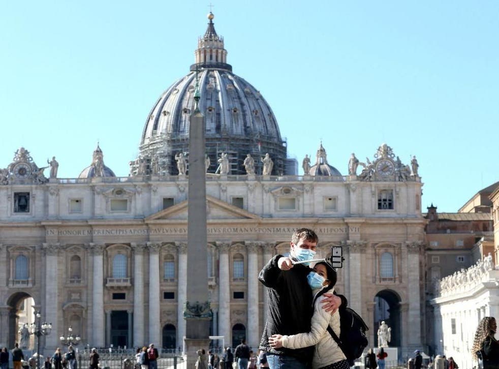 Tourists take a selfie at St Peter's Square on 5 March 2020 in Rome Italy