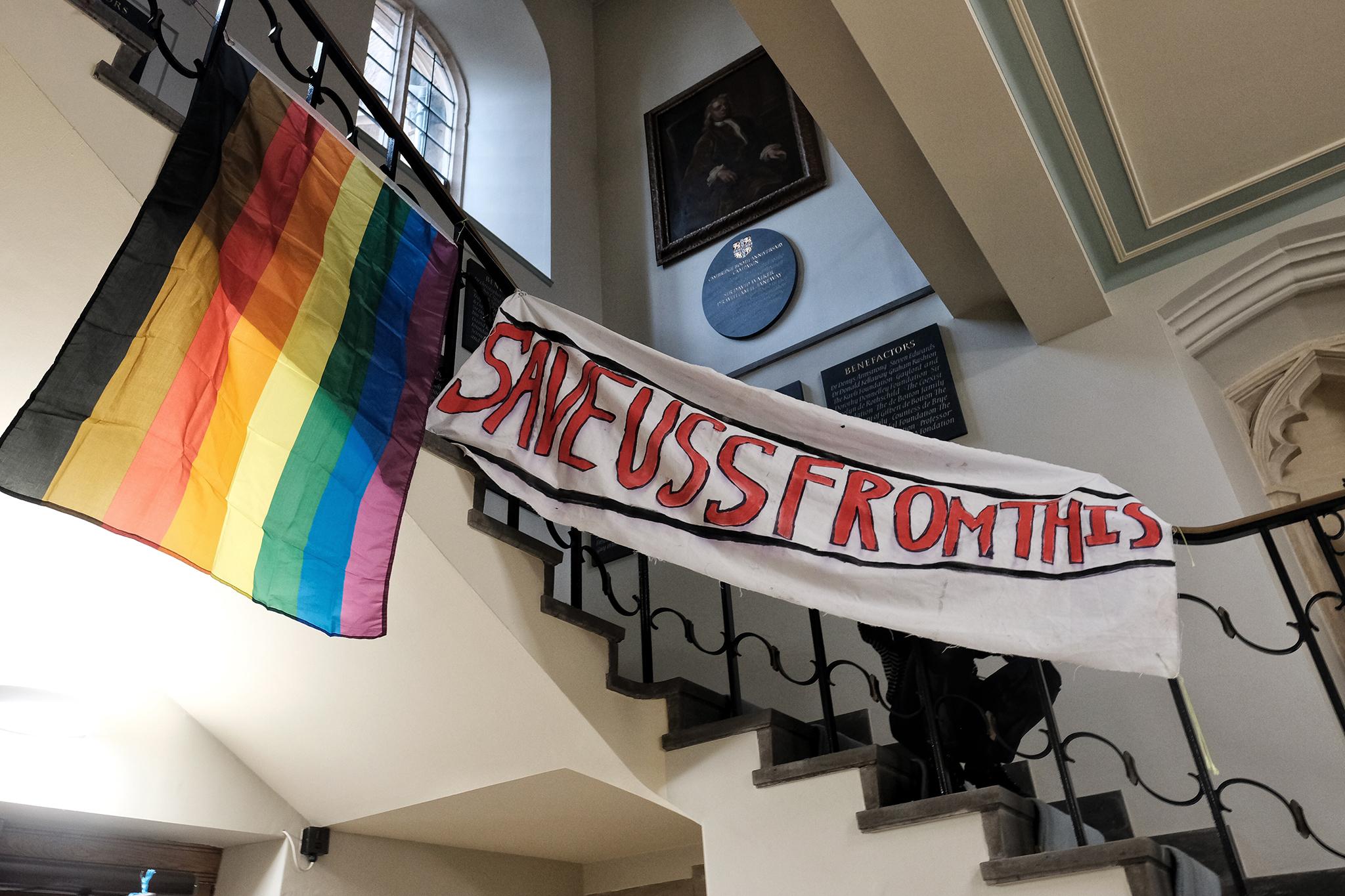 Students hang banners in support of the UCU strikes and a Pride Rainbow flag