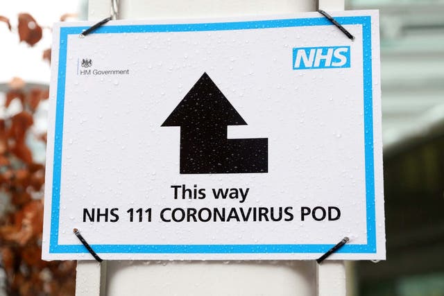 A sign directs patients towards a coronavirus pod, where people who believe they may be suffering from the virus can attend and speak to doctors, at St Thomas' Hospital in London on 5 March 2020.