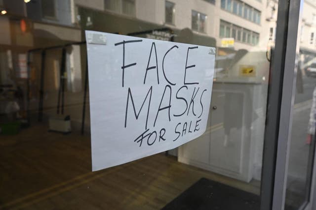Face masks are offered for sale at a shop in Brighton in February