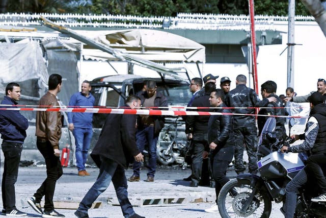 People gather at the site of a suicide attack near the U.S. embassy in Tunis, Tunisia