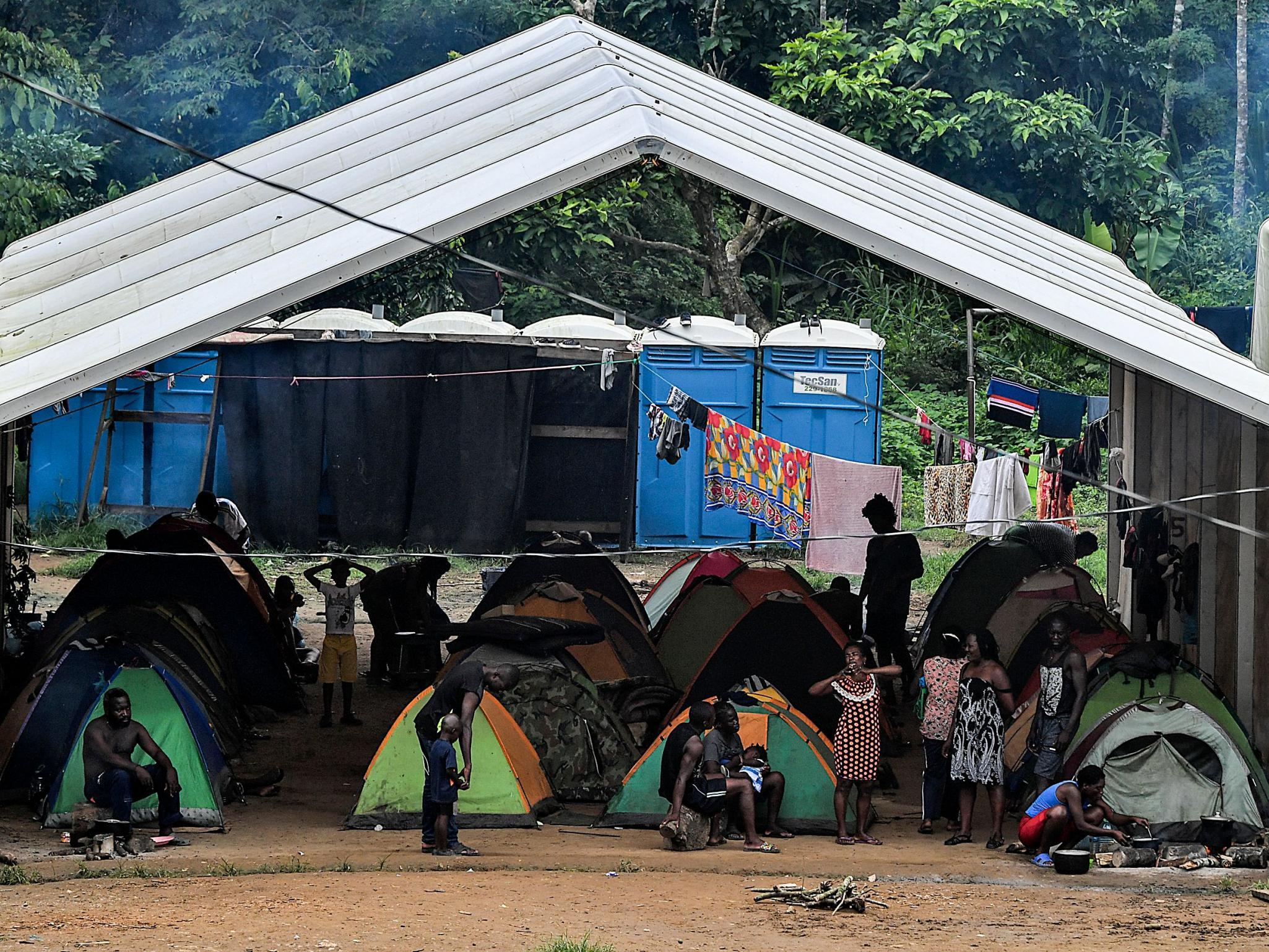 Migrants who have made it through the Darien Gap wait in a refugee camp in Panama