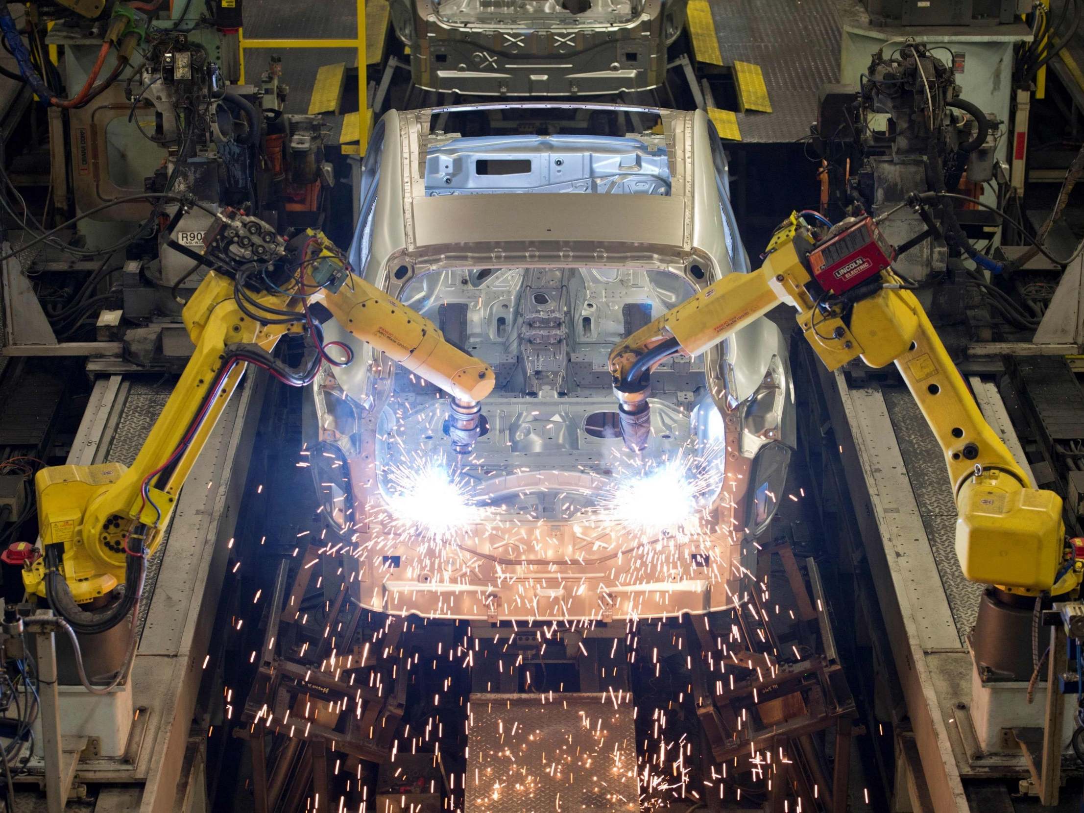 Robots weld vehicle panels at the body shop at Nissan's Sunderland plant