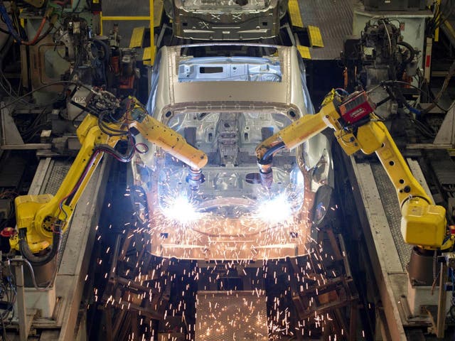 Robots weld vehicle panels at the body shop at Nissan's Sunderland plant