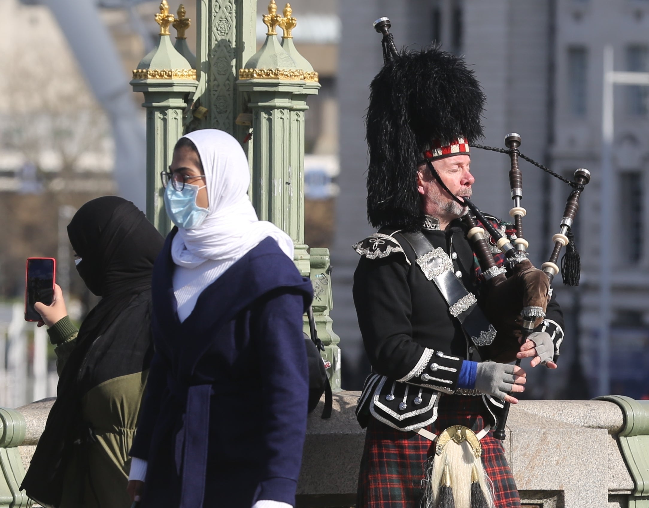 Masks are being worn all around the world as seen here on Westminster Bridge in London (Getty)