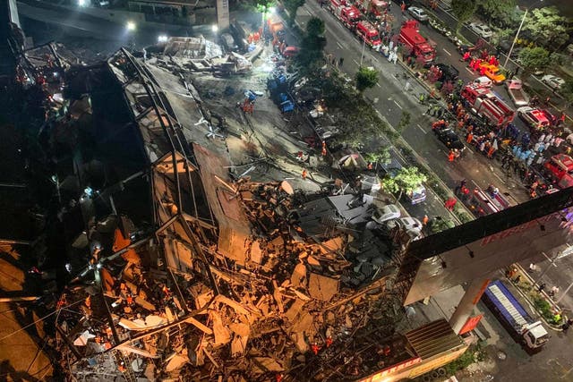 Rescuers search for survivors in the rubble of a collapsed hotel in Quanzhou