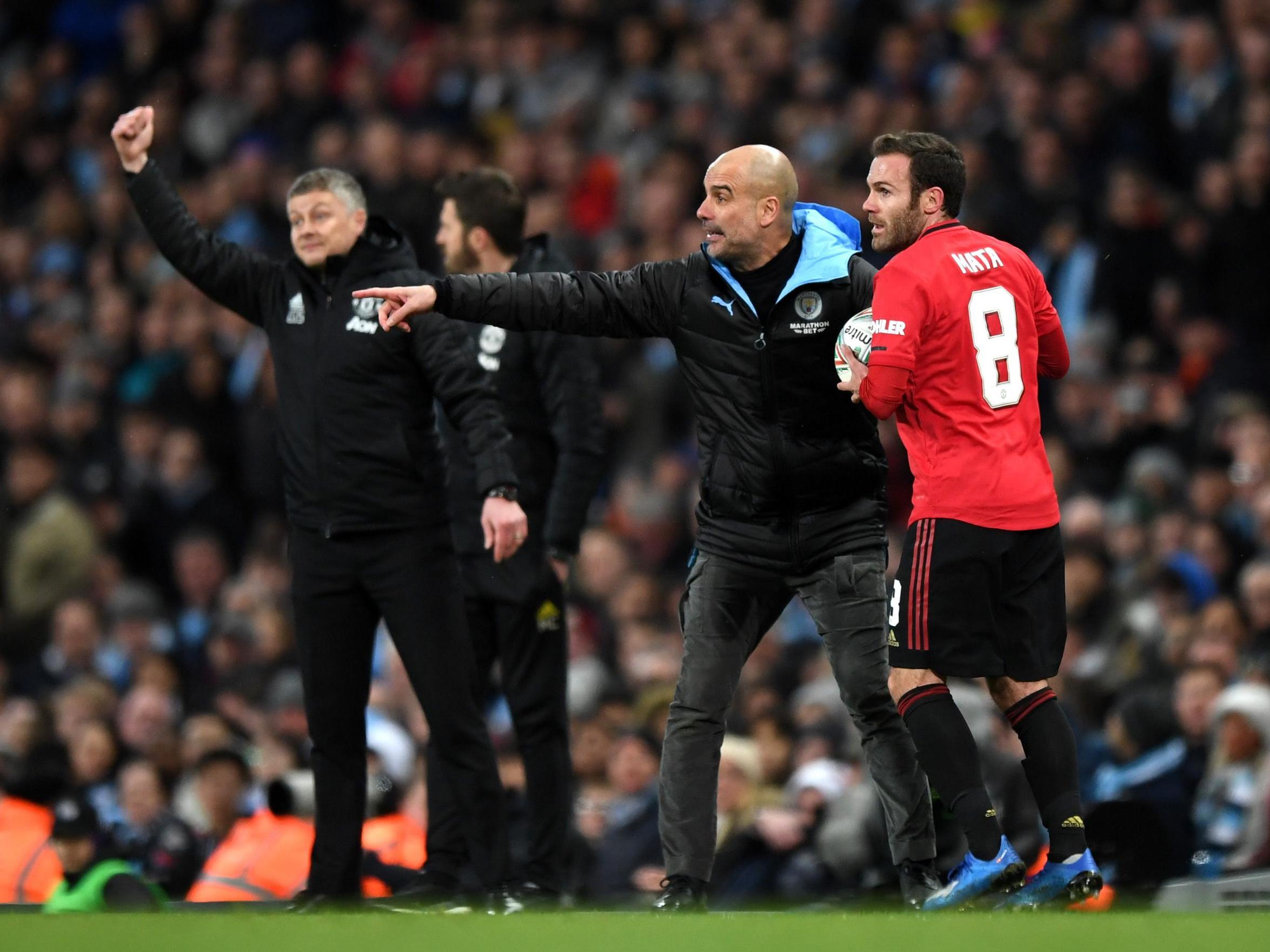 Ole Gunnar Solskjaer and Pep Guardiola react during the Carabao Cup semi-final