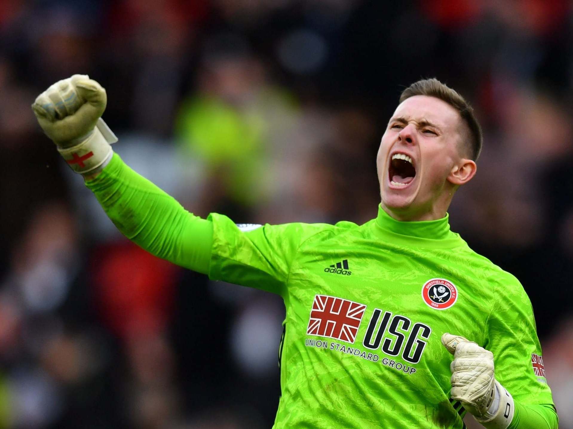 Dean Henderson celebrates a crucial triple save against Norwich