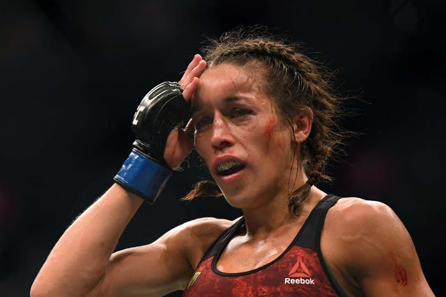 Joanna Jedrzejczyk feels her head after a punishing fight against Weili Zhang