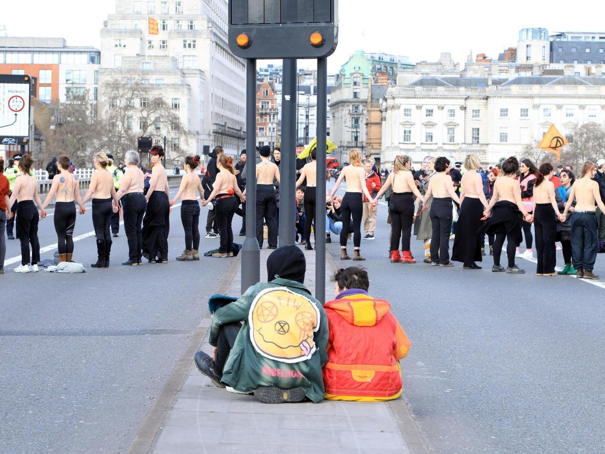 Extinction Rebellion activists go topless and block Waterloo Bridge to protest &apos;climate rape&apos;