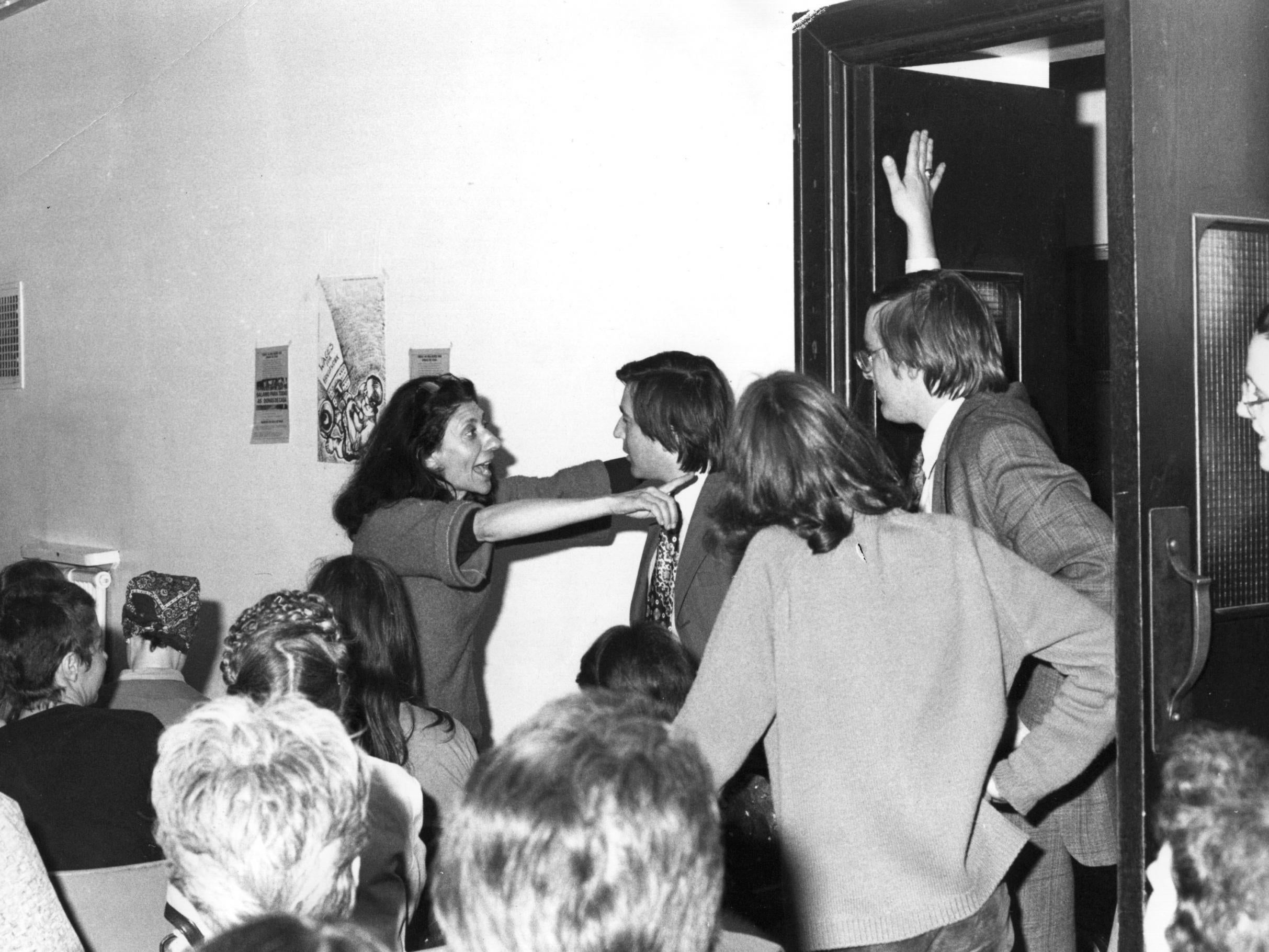 Selma James refuses entry for male members of the press to the launch in 1975 of the Wages For Housework campaign at Conway Hall, Holborn (Getty)