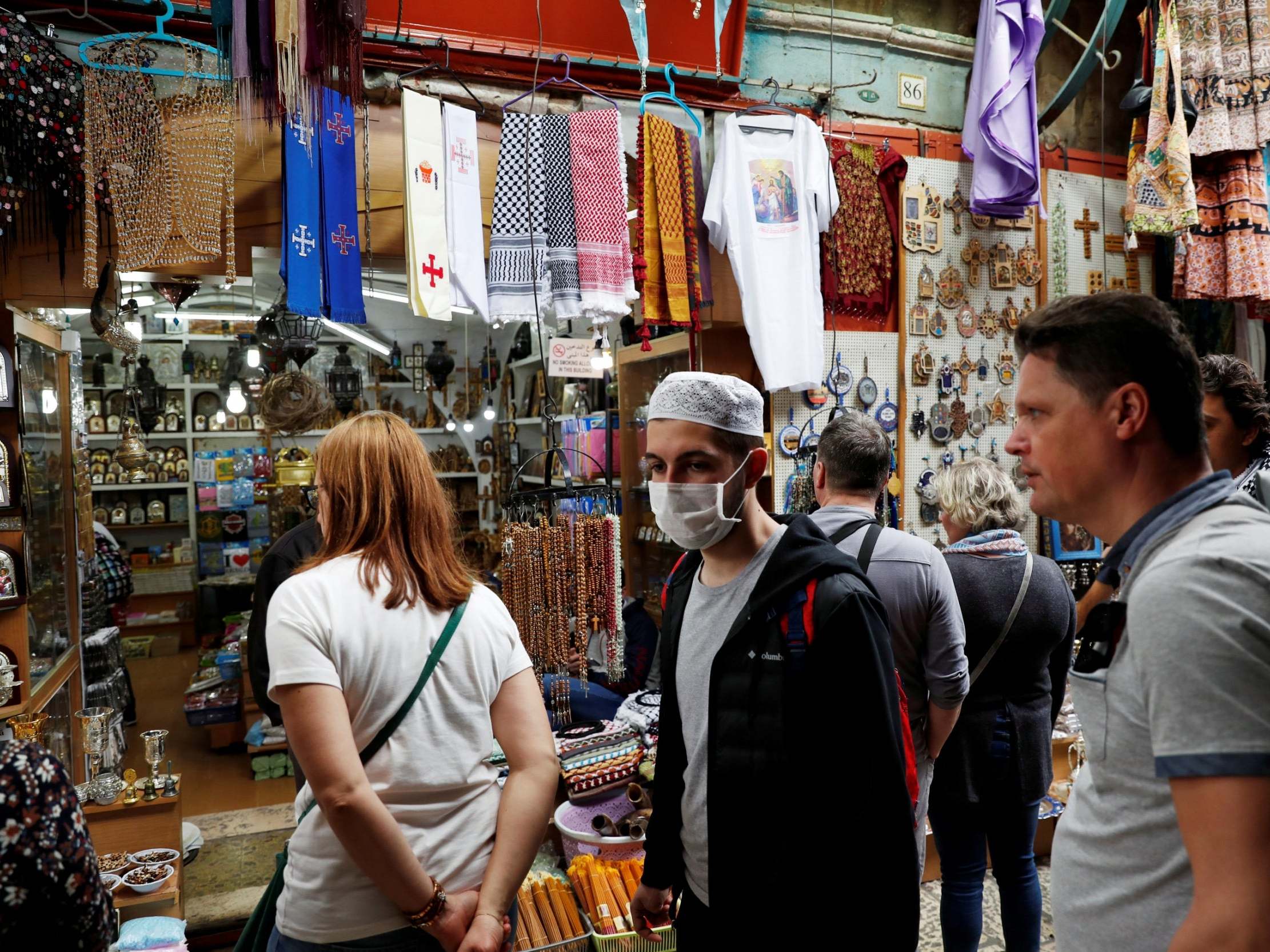 A man wears a face mask for protection as he walks in Jerusalem's Old City