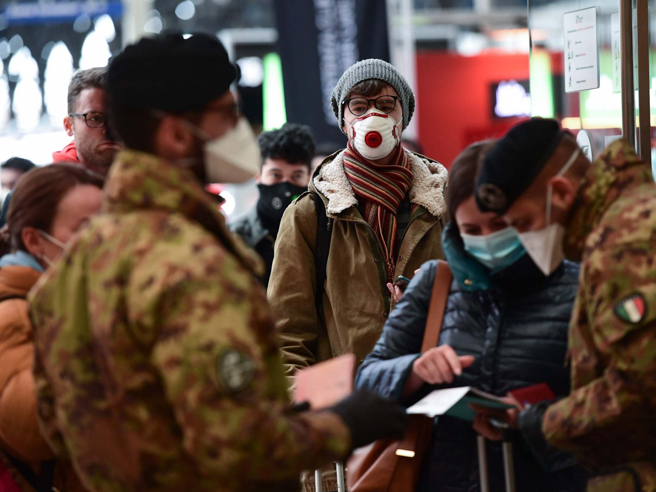 Soldiers wearing masks control passengers arriving at the Milan Central railway station on March 9