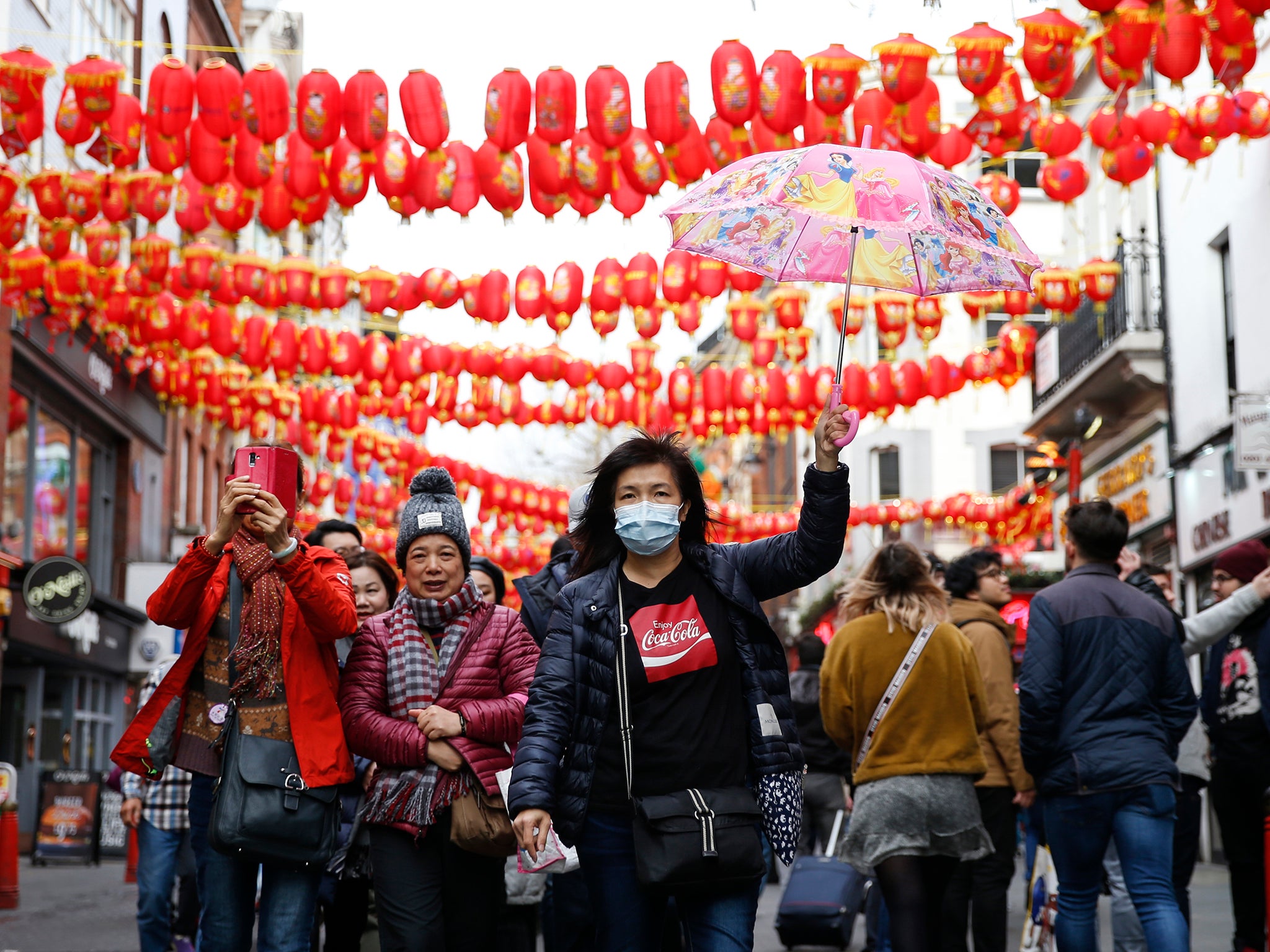 A woman wears a face mask in Chinatown following the rise of global cases
