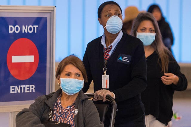 Passengers and staff wear face masks at LAX