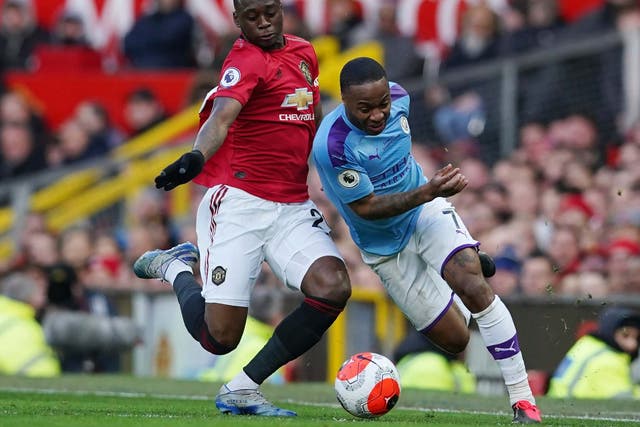 Manchester United's Aaron Wan-Bissaka, left, and Manchester City's Raheem Sterling