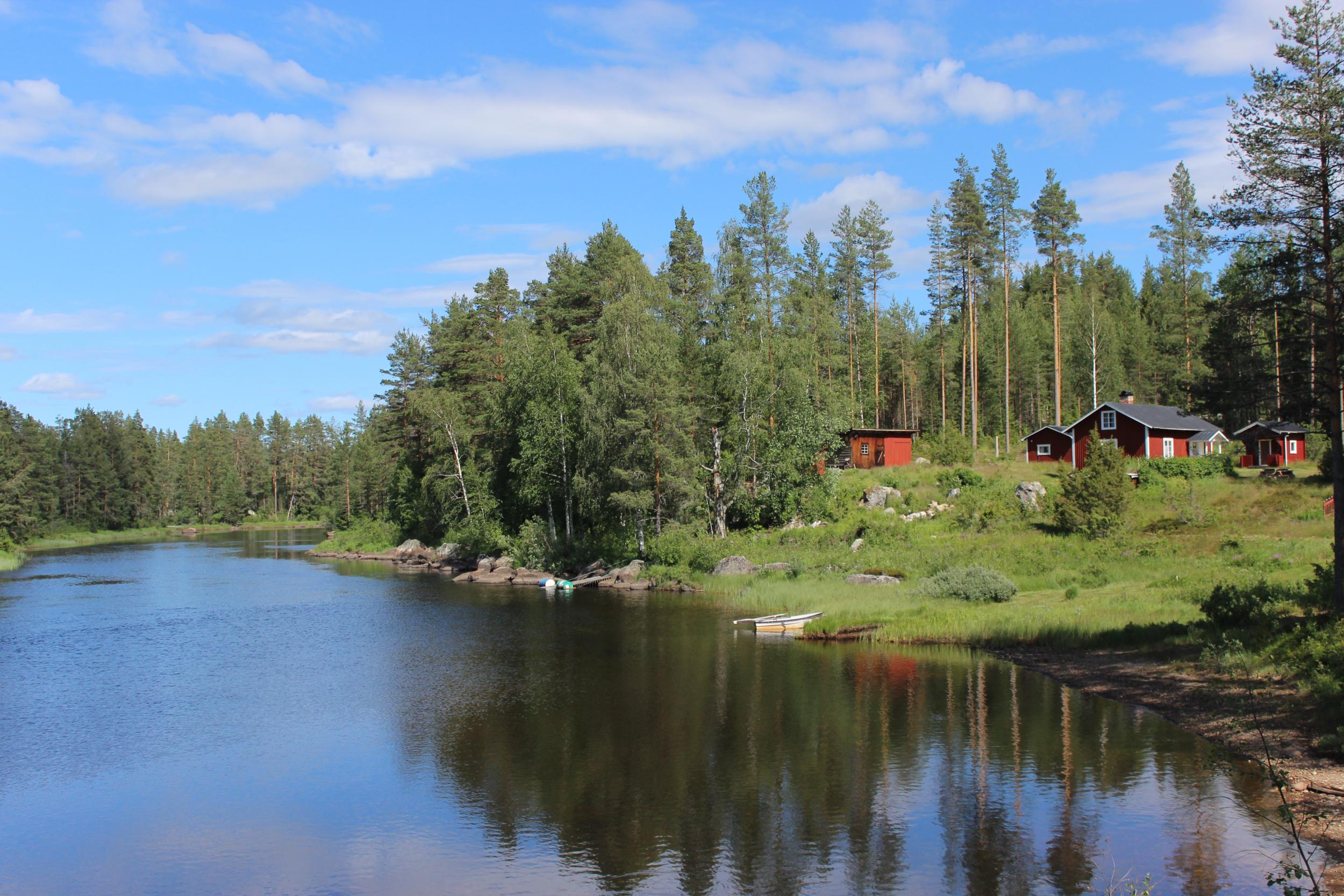Falu-red huts by the lake in Dalarna County