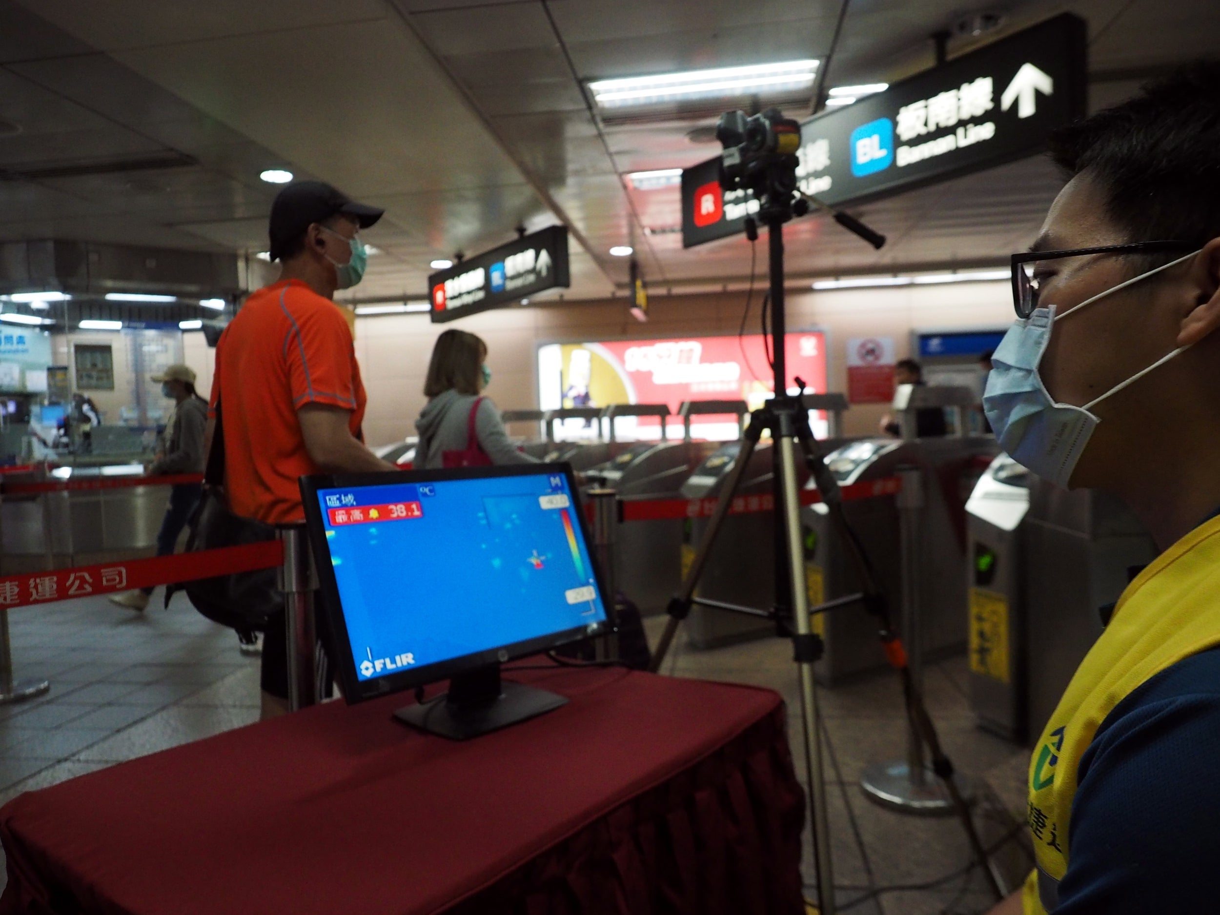 A thermal scanner monitors passengers’ temperatures at a station in Taipei