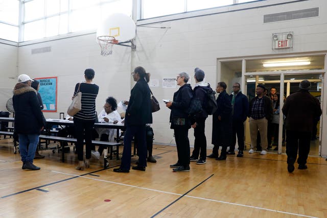 Voters in Michigan line up to cast their ballots in the Democratic presidential primary on 10 March.