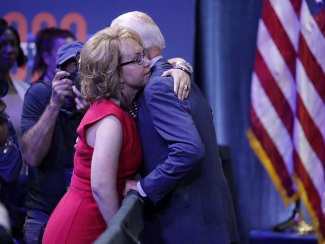 Gabby Giffords and Joe Biden embrace during a gun safety forum