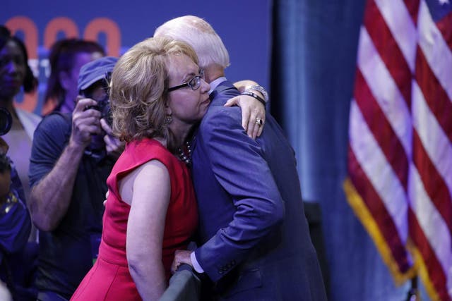 Gabby Giffords and Joe Biden embrace during a gun safety forum