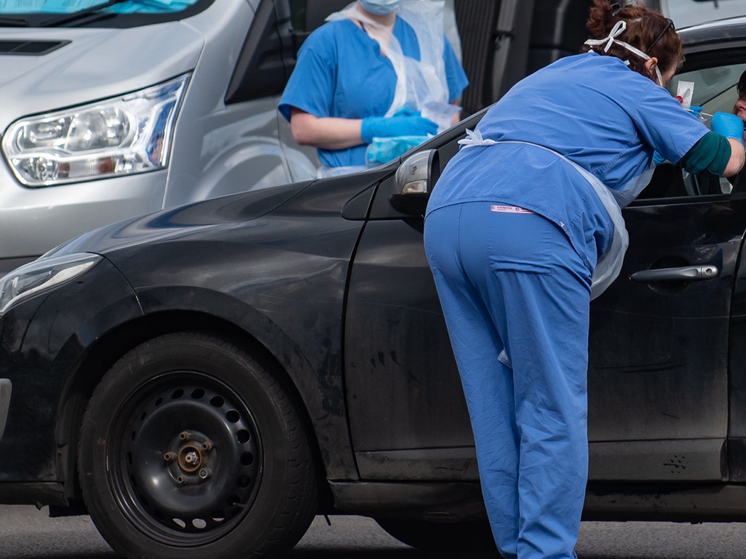 People are swabbed at a similar drive-thru coronavirus testing station in Wolverhampton in the UK