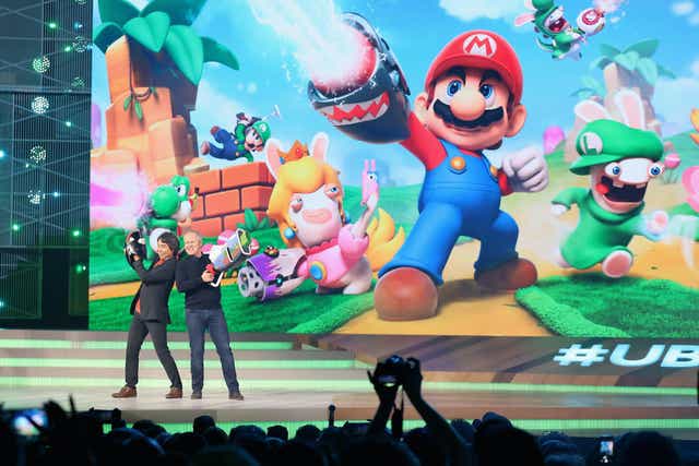 Nintendo co-Representative Director and Creative Fellow Shigeru Miyamoto (L) and Ubisoft Co-founder and CEO Yves Guillemot pose together on stage during the Ubisoft E3 conference at the Orpheum Theater on June 12, 2017 in Los Angeles, California