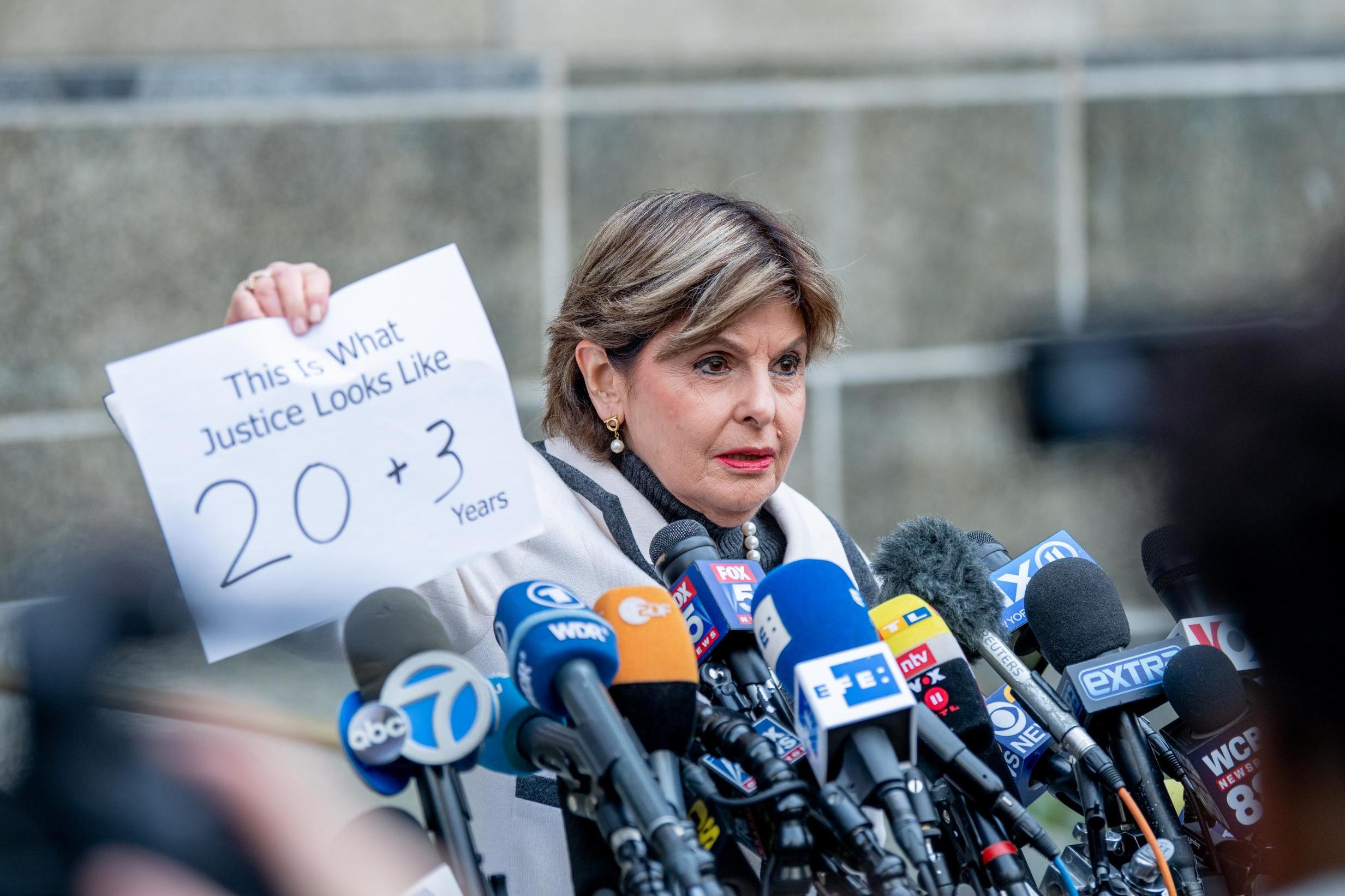 Attorney Gloria Allred holds a sign after Harvey Weinstein was sentenced to 23 years in prison on 11 March 2020 in New York City.