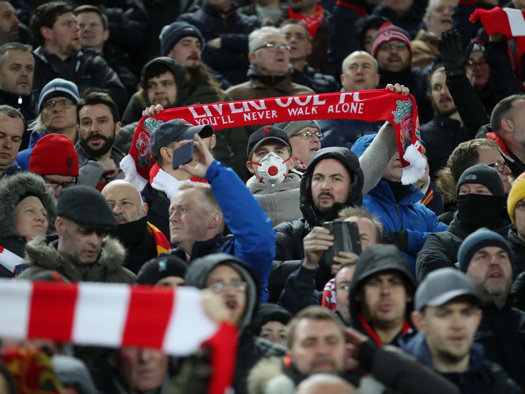 General view of a Liverpool fan wearing a face mask
